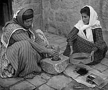 Arab women grinding coffee in Palestine