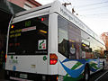 A hydrogen fuel cell public bus accelerating at traffic lights in Perth, Western Australia.