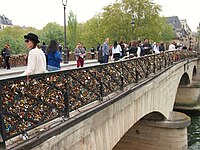 Love padlocks and tourists on the Pont de l'Archevêché in Paris