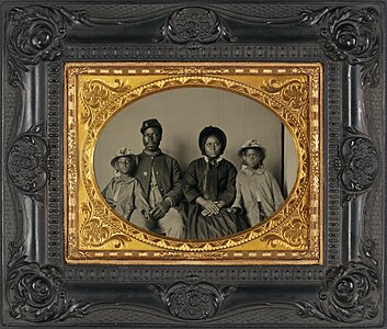 "Sgt._Samuel_Smith,_African_American_soldier_in_Union_uniform_with_wife_and_two_daughters.jpg" by User:Yann