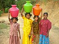 Girls carrying water in India