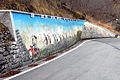 Public mural painting by the artists Giuseppe Brombin and Floreano "Jan" Franzil featuring famous Italian cyclists of the past, situated on the side of the road to Interneppo.