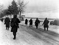 The 101st Airborne troops move out of Bastogne, after having been besieged there for ten days, to drive the enemy out of the surrounding district. (12/31/44)