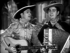 Gene Autry and Smiley Burnette singing in In Old Santa Fe film, 1934.png