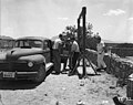 Herb Lehr and Harry Daghlian loading the assembled tamper plug into a car for transport to the shot tower.