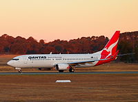 A Qantas Boeing 737 taking off at sunset