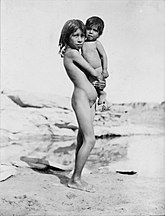 Pueblo Indian girl holding small child