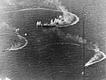 Japanese aircraft carrier Zuikaku (center) and two destroyers maneuvering, while under attack by U.S. Navy carrier aircraft, during the late afternoon of 20 June 1944. Zuikaku was hit by several bombs during these attacks, but survived. (Battle of the Philippine Sea, June 1944)