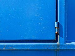 Hinge on blue dumpster