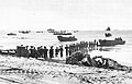 Troops unloading supplies at Aitape. In the background are the two AK's.