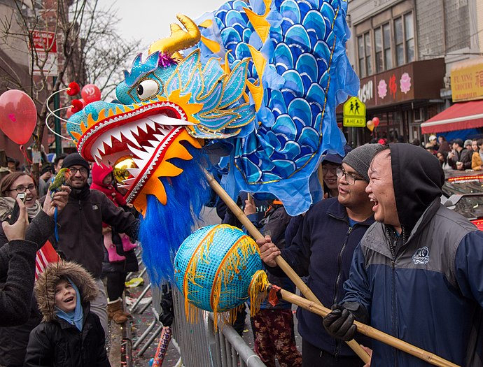 Dragon dance meets a bird at the NYC Lunar New Year parade in 2018